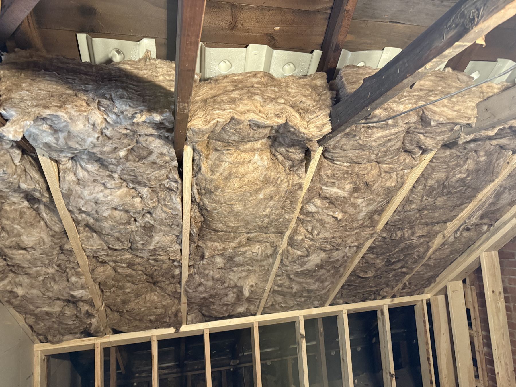 Attic insulation batts installed between rafters
