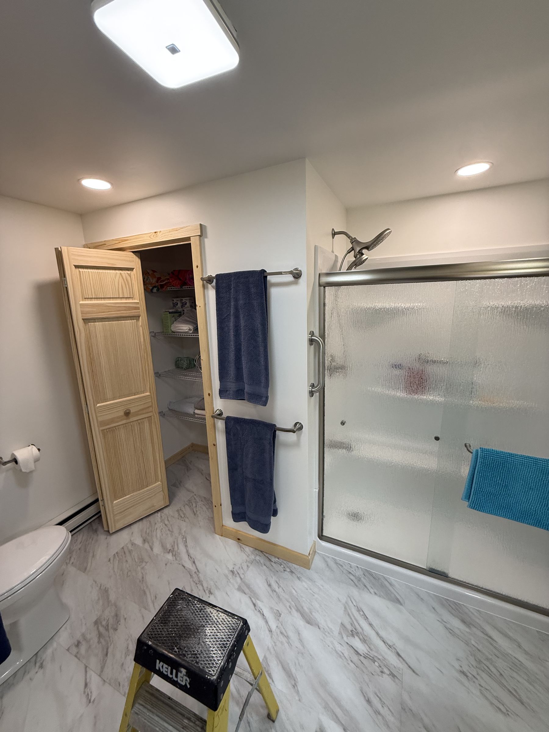 Bathroom remodel with built-in linen closet
