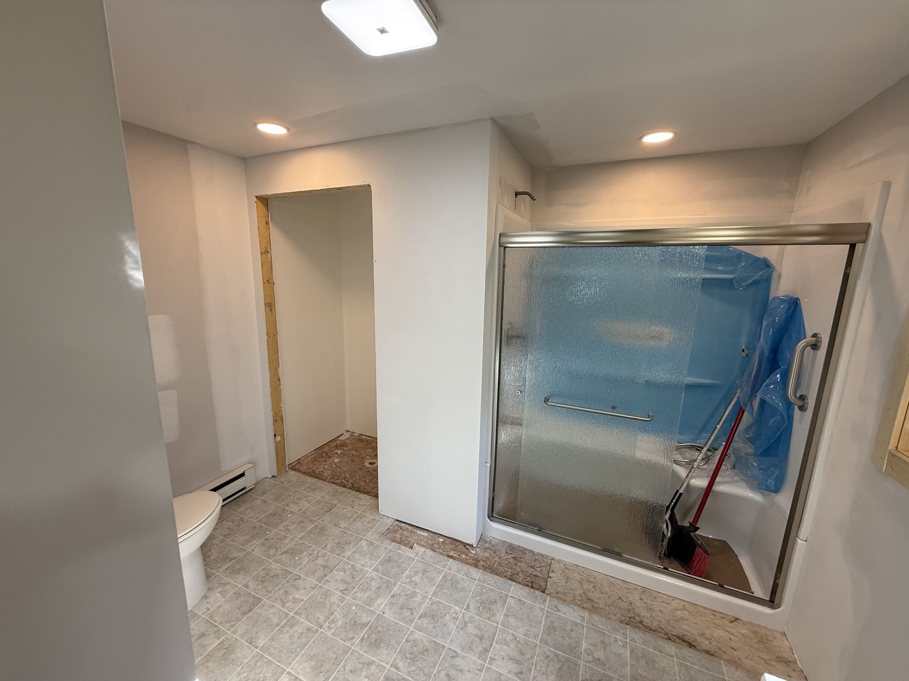 Bathroom shower glass door installation in progress